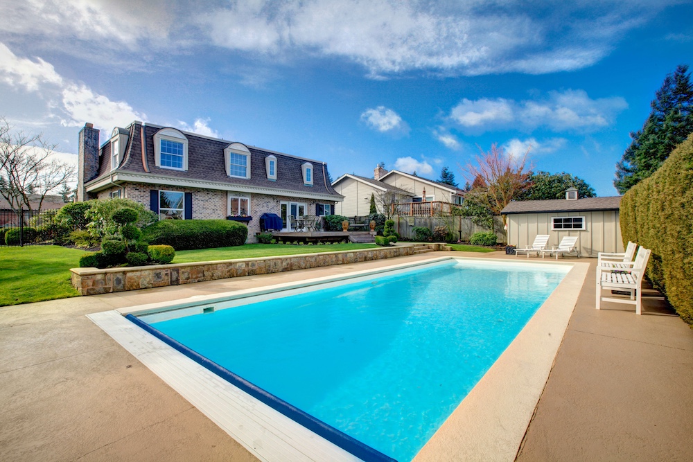 Large Backyard With Flowerbed And Swimming Pool